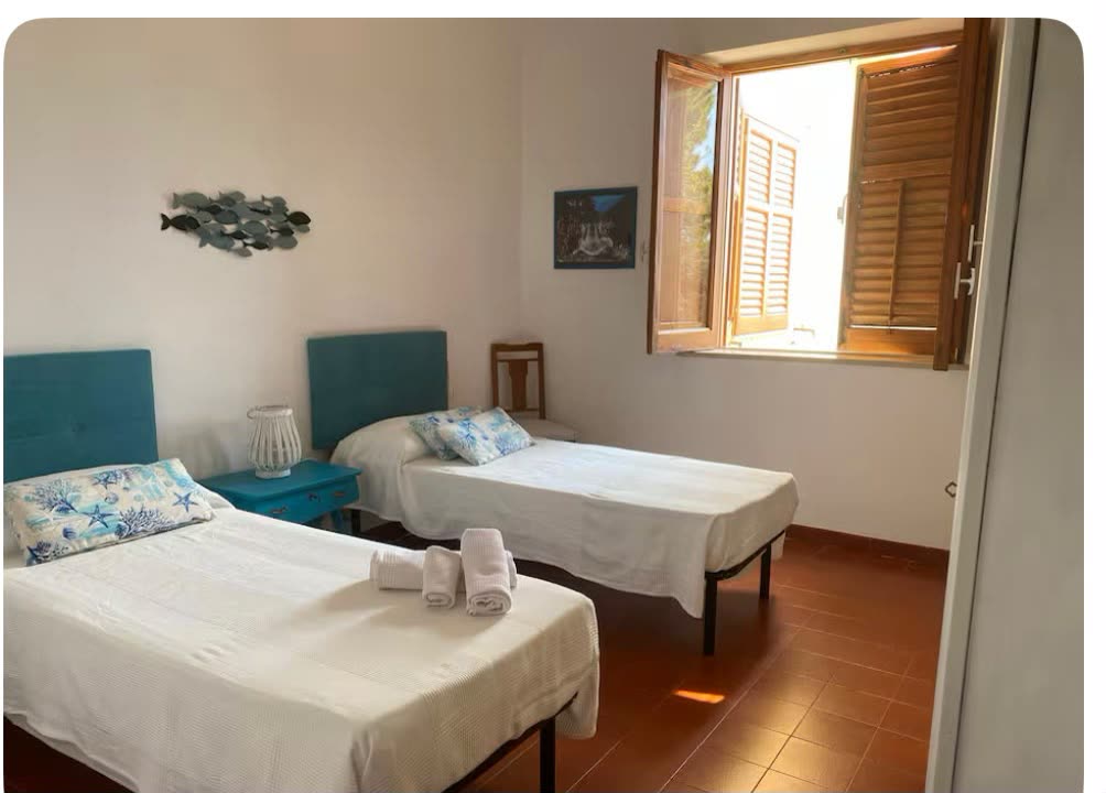 Bedroom with two single beds and turquoise headboards