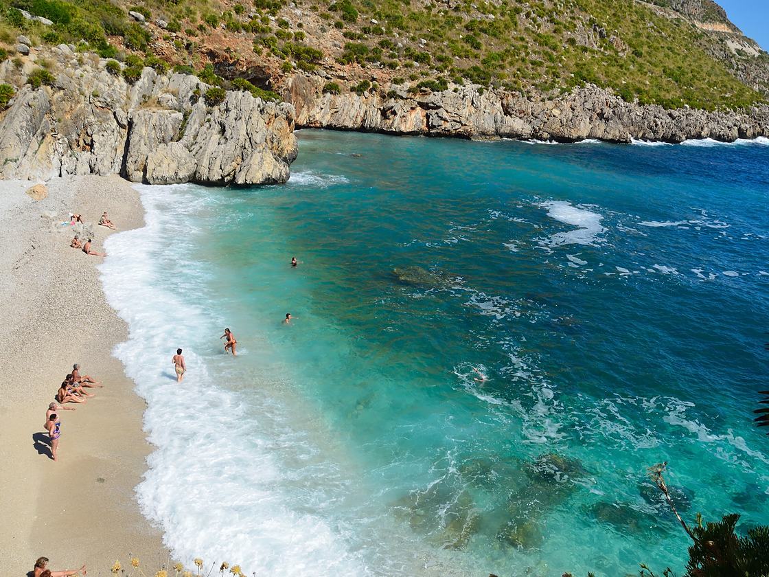 A cove of white pebbles and turquoise sea in the Zingaro Reserve